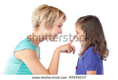 beautiful and happy young mother and small daughter smiling and looking at each other. Mother pushing daughter on nose with her finger. Studio shot, isolated on white background