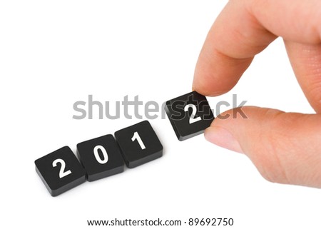 Numbers 2012 and hand isolated on white background