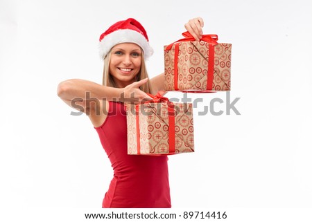 Portrait of young beautiful woman in santa claus hat with two christmas red and golden gift boxes with red ribbons.