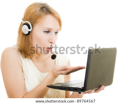 woman operator sends a kiss with a laptop and headphones.