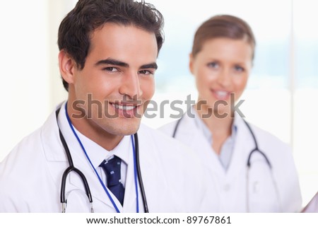 Smiling young medical assistants standing next to each other