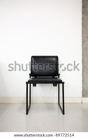 black leather chair over wall