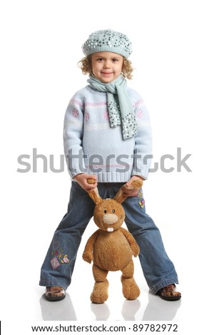 portrait of a little girl with soft toys on a white background