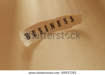 A word written on a ripped piece of paper isolated on beige background