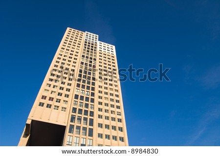 colorful brick skyscraper under a deep blue sky