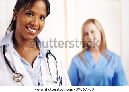 Portrait of a doctor with one of his co-workers on the background