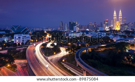The scenario of Kuala Lumpur city, taken with slow shutter speed to get the light trail from the highway traffic. Stunning light trail at highway in Kuala Lumpur city