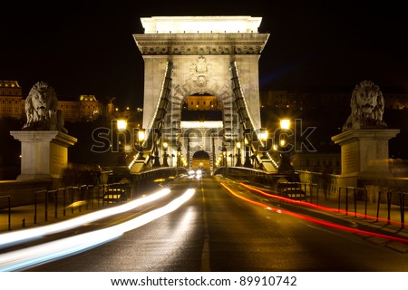 Chain bridge at night with cars in Budapest, Hungary