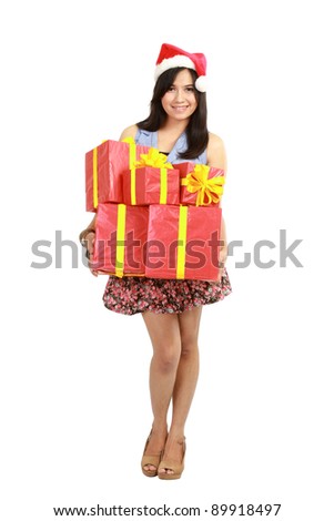 Christmas shopping woman holding gifts wearing red Santa hat isolated on white background.