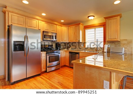 Kitchen with hardwood floor and granite.