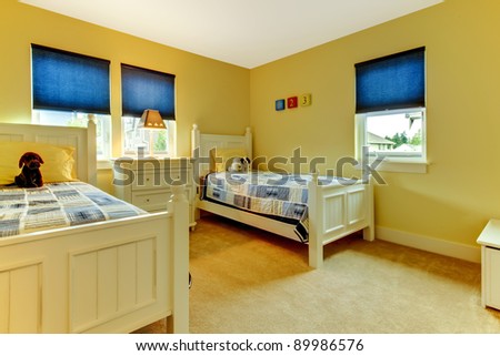 Cute and cozy kids bedroom in yellow and blue.