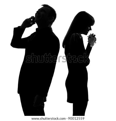 one caucasian couple standing back to back man on the phone  and woman crying in studio silhouette isolated on white background