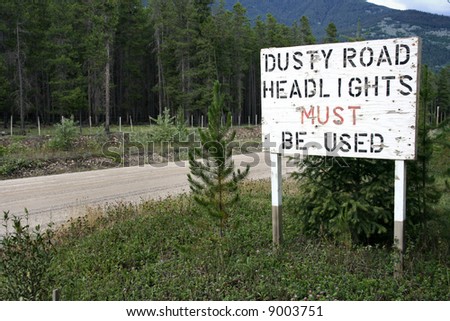 "Dusty road" roadsign on a gravel route in British Columbia, Canada. Near Valemount.
