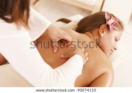 Closeup of masseur's hands doing massage treatment.?