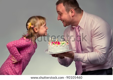 Little girl in her birthday with her father