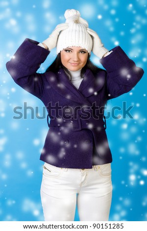 Portrait of the beautiful woman in winter fashion. Studio photo with snowflake imitation.