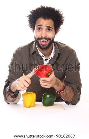 fashion man cutting a pepper