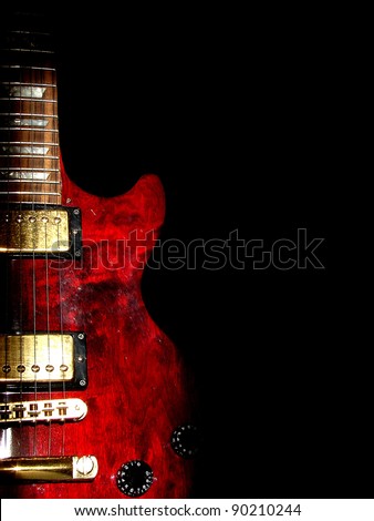 music concept with red electric guitar isolated on black background in dark