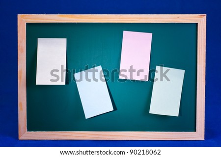 Green chalk board with four colorful sticky notes