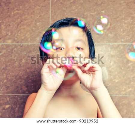Young boy having fun with bubbles (nostalgic style)
