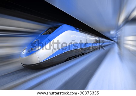 fast train traveling at high speed through a station Royalty-Free Stock Photo #90375355