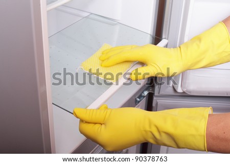 Hands cleaning refrigerator. Royalty-Free Stock Photo #90378763