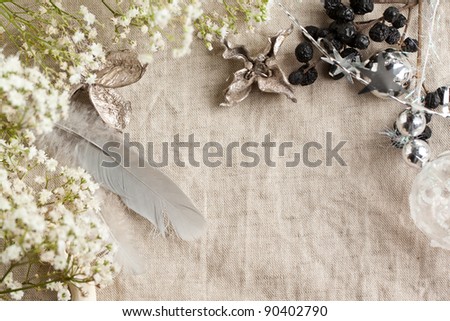 Background with white gypsophila flowers and christmas toys on linen cloth
