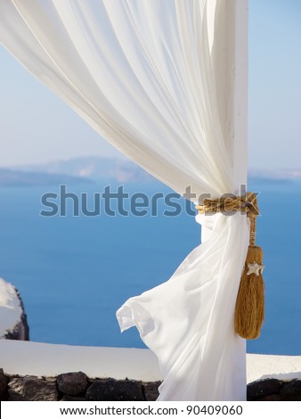 White curtain, detail of white tent on a sea background. Beautiful view of Santorini, Greece. Best luxury resort place for relax and vacations Royalty-Free Stock Photo #90409060