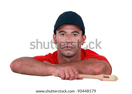 Bored man holding a paintbrush