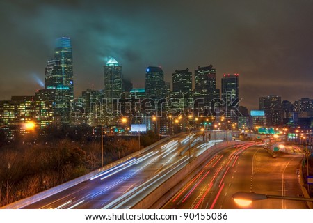 The Philadelphia, Pennsylvania skyline at night with the Schuylkill Expressway in the foreground.