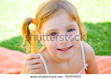 blond kid girl eating one salted bagel in the garden