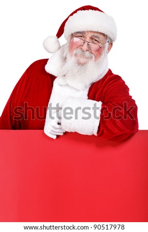 Santa Claus leaning on blank red billboard, isolated on white background