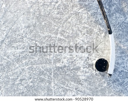 Hockey stick and puck on ice