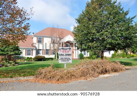 Landscaper Sign on front yard lawn of Suburban Home during Blue Sky Day