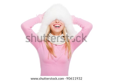 attractive excited smile woman fun laughing, wear winter fur hat pulled down over the eyes, and pink sweater, knit scarf, isolated over white background