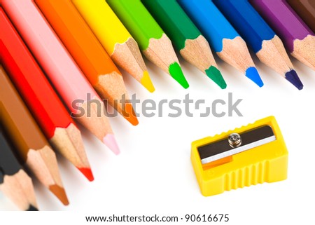 Multicolored pencils and sharpener isolated on white background