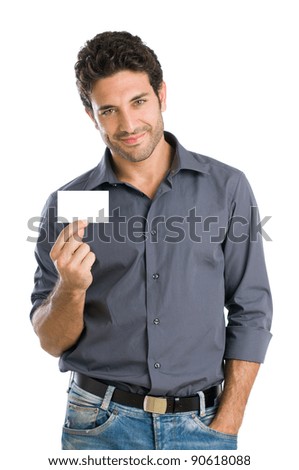 Satisfied young beautiful man holding and showing blank card ready for your text
