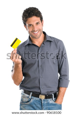Happy smiling young man holding a credit card isolated on white background