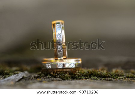 two golden wedding rings on ground