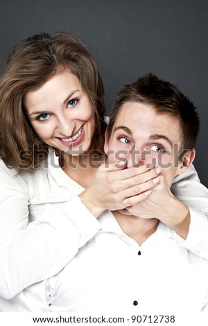 young couple together on black background
