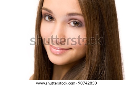 Closeup portrait of beautiful young brunette girl with light makeup.