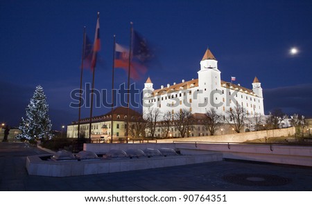 bratislava - castle from parliament at night and christmas tree and flags