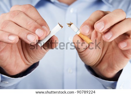 Quit smoking, human hands breaking the cigarette Royalty-Free Stock Photo #90789224