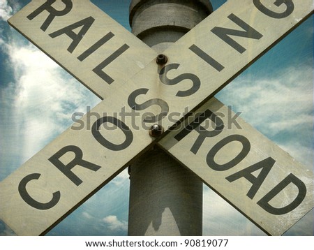 aged and worn vintage photo of railroad crossing sign