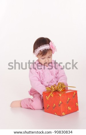 Adorable little girl with red gift box