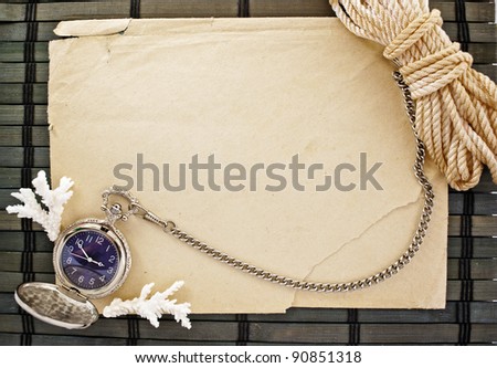 Marine theme frame of paper sheet, watches and sailor rope on a wooden mat.