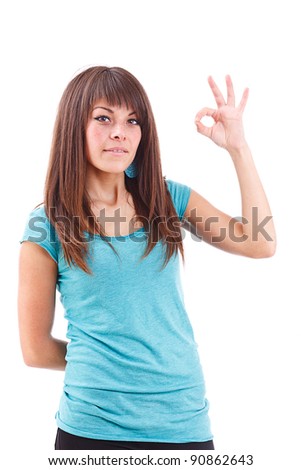 Portrait of beautiful young woman gesturing a okay sign on white background