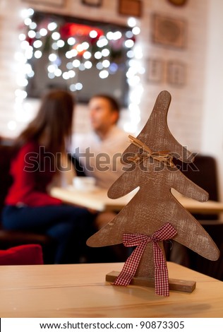 Christmas time. Young couple in cafe at the evening