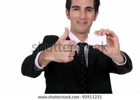 Happy businessman with card
