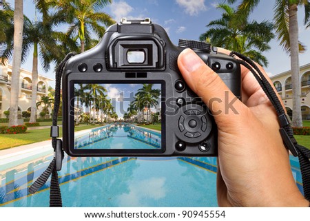DSLR  camera in hand shooting tropical resort scenery (my photo)